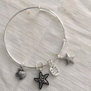 Womens Wire Sliver colored Bracelet with four charms. NWOT